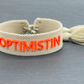 OPTIMISTIN Statement Armband gewebt, bestickt